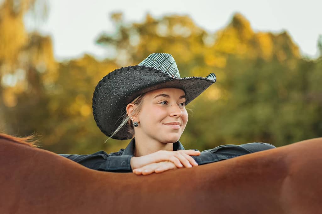 western cowgirl with her red mare at the mill Cleveland, tn