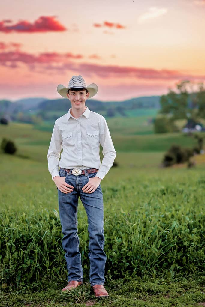 Cowboy standing in front of field